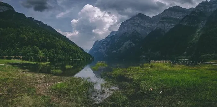 Framed Print : panorama of beautiful mountain lake in the swiss alps covered in dramatic clouds, klontalersee switzerland