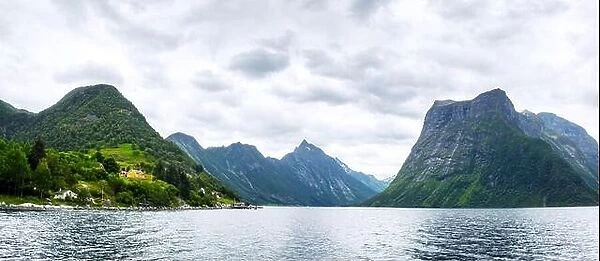 Panorama of dramatic evening view of Hjorundfjorden fjord near Urke village, Norway. Landscape photography