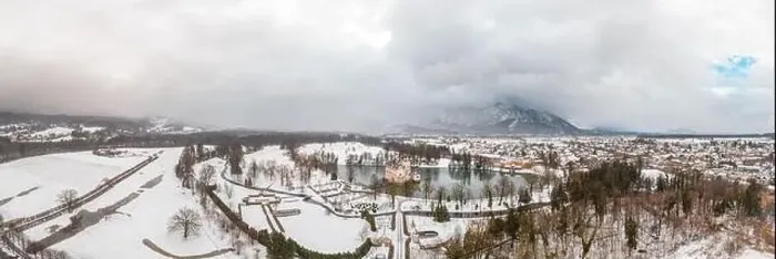 Framed Print : Panoramic aerial drone shot of Anif Schloss moated castle in artificial pond at Salzburg outskirts in heavy snow during Framed Print : Panoramic aerial drone shot of Anif Schloss moated castle in artificial pond at Salzburg outskirts in heavy snow during