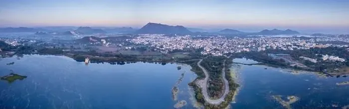Framed Print : Panoramic aerial drone shot at dawn dusk with road loop extending into fateh sagar lake with aravalli hills in distance Framed Print : Panoramic aerial drone shot at dawn dusk with road loop extending into fateh sagar lake with aravalli hills in distance