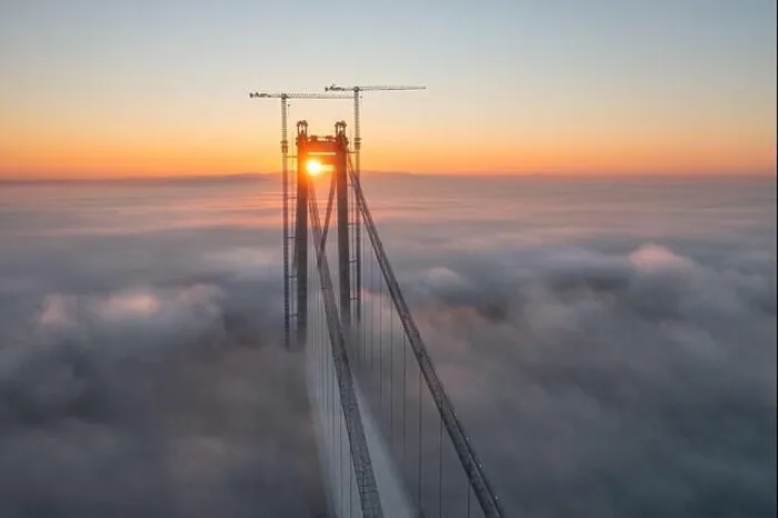 Framed Print : Panoramic aerial drone view from above of the suspended bridge over danube river, under construction, between Braila and Tulcea cities in Romania Framed Print : Panoramic aerial drone view from above of the suspended bridge over danube river, under construction, between Braila and Tulcea cities in Romania