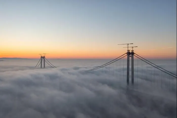 Framed Print : Panoramic aerial drone view from above of the suspended bridge over danube river, under construction, between Braila and Tulcea cities in Romania Framed Print : Panoramic aerial drone view from above of the suspended bridge over danube river, under construction, between Braila and Tulcea cities in Romania