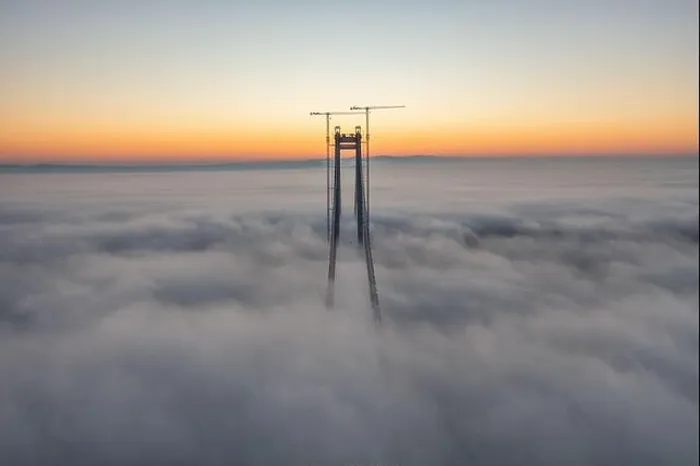 Framed Print : Panoramic aerial drone view from above of the suspended bridge over danube river, under construction, between Braila and Tulcea cities in Romania