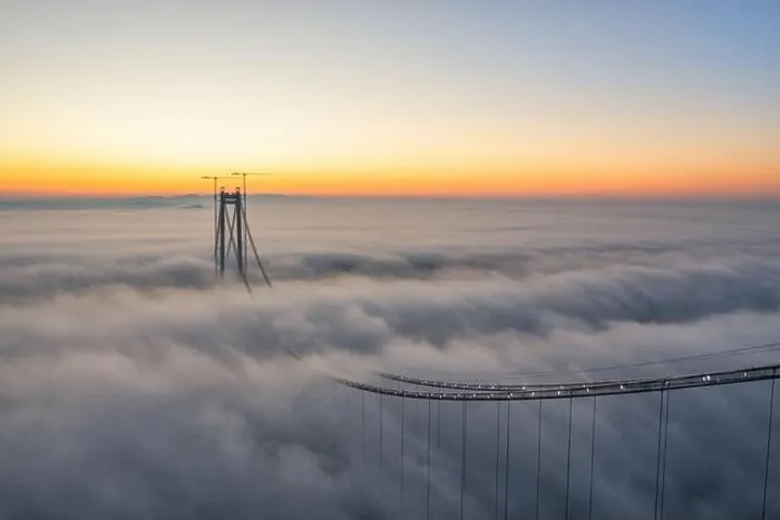 Framed Print : Panoramic aerial drone view from above of the suspended bridge over danube river, under construction, between Braila and Tulcea cities in Romania