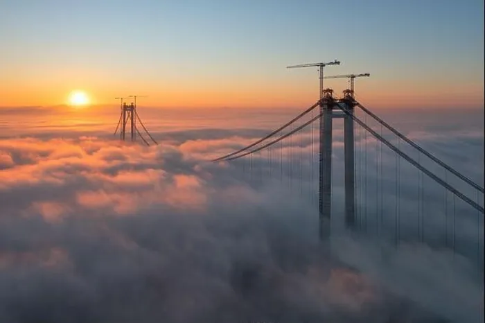 Framed Print : Panoramic aerial drone view from above of the suspended bridge over danube river, under construction, between Braila and Tulcea cities in Romania
