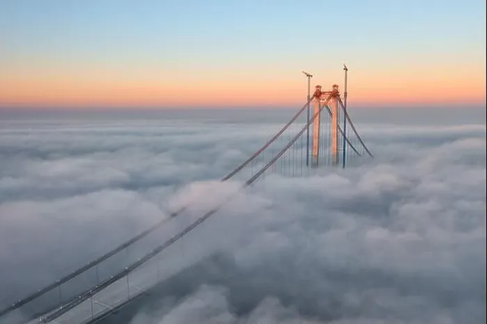 Framed Print : Panoramic aerial drone view from above of the suspended bridge over danube river, under construction, between Braila and Tulcea cities in Romania Framed Print : Panoramic aerial drone view from above of the suspended bridge over danube river, under construction, between Braila and Tulcea cities in Romania