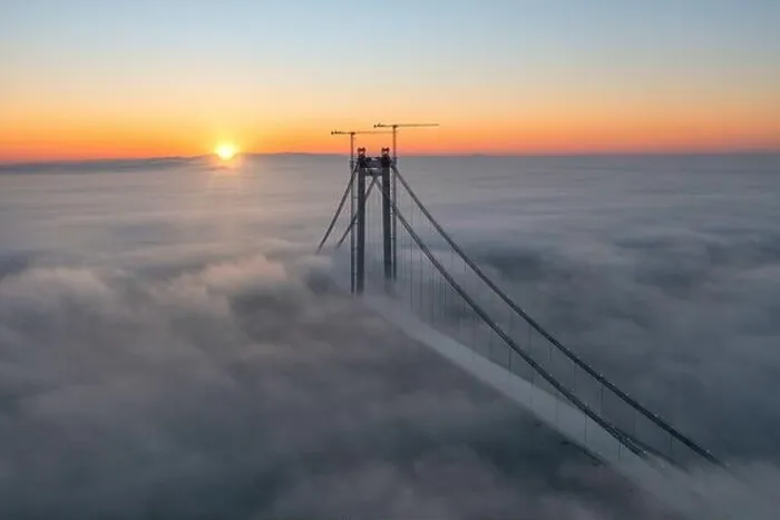 Framed Print : Panoramic aerial drone view from above of the suspended bridge over danube river, under construction, between Braila and Tulcea cities in Romania
