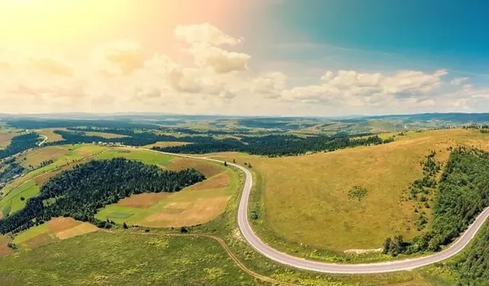 Framed Print : Panoramic aerial view of the countryside, country road, and cultivated and uncultivated fields in the hills Framed Print : Panoramic aerial view of the countryside, country road, and cultivated and uncultivated fields in the hills