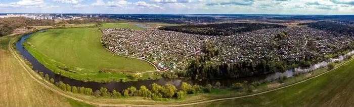 Framed Print : Panoramic aerial view of dense dacha development in river valley, countryside from drone Framed Print : Panoramic aerial view of dense dacha development in river valley, countryside from drone