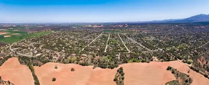 Framed Print : Panoramic aerial view of a large urbanization of country houses next to the mountain Framed Print : Panoramic aerial view of a large urbanization of country houses next to the mountain
