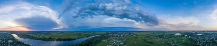 Framed Print : Panoramic aerial view of the nature landscape with green meadows and a river at sunset Framed Print : Panoramic aerial view of the nature landscape with green meadows and a river at sunset