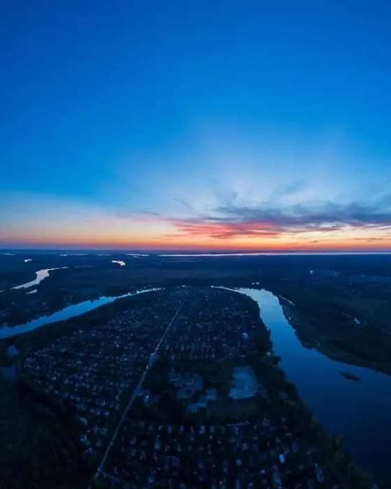 Framed Print : Panoramic aerial view of the nature landscape with green meadows and a river at sunset Framed Print : Panoramic aerial view of the nature landscape with green meadows and a river at sunset