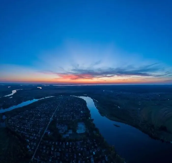 Framed Print : Panoramic aerial view of the nature landscape with green meadows and a river at sunset Framed Print : Panoramic aerial view of the nature landscape with green meadows and a river at sunset