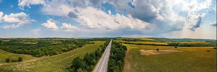 Framed Print : Panoramic aerial view of road between fields. Birds-eye view of the land with fields, meadows, and forest Framed Print : Panoramic aerial view of road between fields. Birds-eye view of the land with fields, meadows, and forest