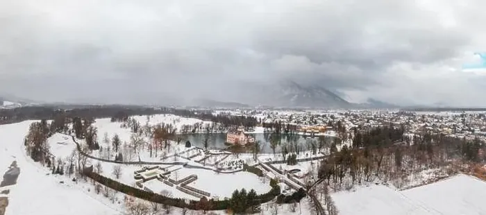 Framed Print : Panoramic aerial view of Schloss Anif castle moated in artificial pond near Salzburg outskirts in heavy snow during Framed Print : Panoramic aerial view of Schloss Anif castle moated in artificial pond near Salzburg outskirts in heavy snow during