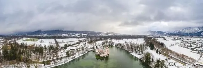 Framed Print : Panoramic aerial view of Schloss Anif castle moated in artificial pond at Salzburg outskirts in heavy snow during Framed Print : Panoramic aerial view of Schloss Anif castle moated in artificial pond at Salzburg outskirts in heavy snow during