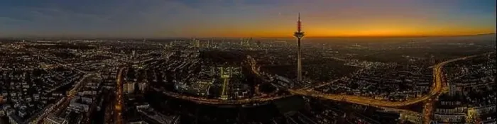 Framed Print : Panoramic drone image of the Frankfurt skyline with television tower in the evening during a colorful Framed Print : Panoramic drone image of the Frankfurt skyline with television tower in the evening during a colorful