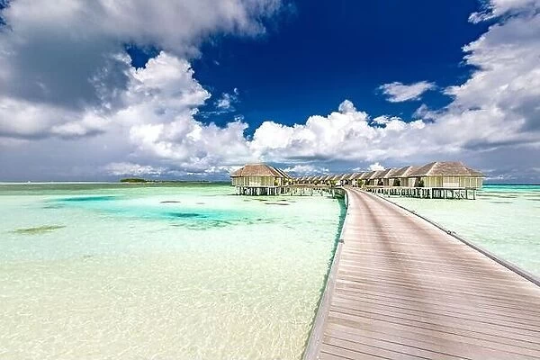 Panoramic landscape of Maldives beach. Tropical panorama, luxury water villa resort with wooden pier or jetty. Luxury travel destination background