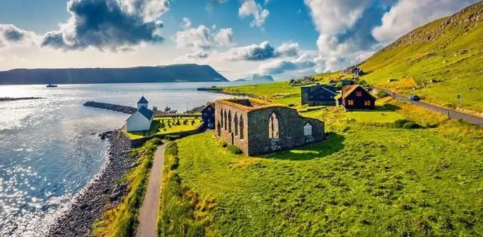 Framed Print : Panoramic summer view from flying drone of Kirkjubour village with Hestur Island on background