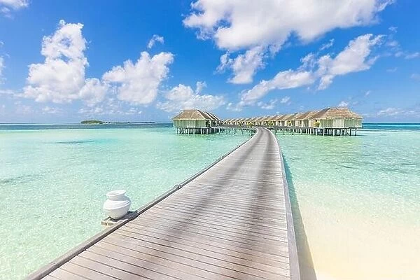 Panoramic travel landscape of Maldives beach. Tropical panorama, luxury water villa resort with wooden pier or jetty, blue sky. Luxury honeymoon