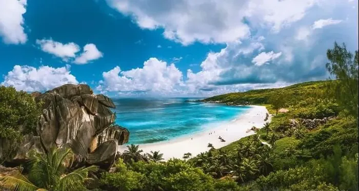 Framed Print : Panoramic view of beautiful Grand Anse beach on La Digue island in Seychelles. Blue lagoon with white clouds above Framed Print : Panoramic view of beautiful Grand Anse beach on La Digue island in Seychelles. Blue lagoon with white clouds above