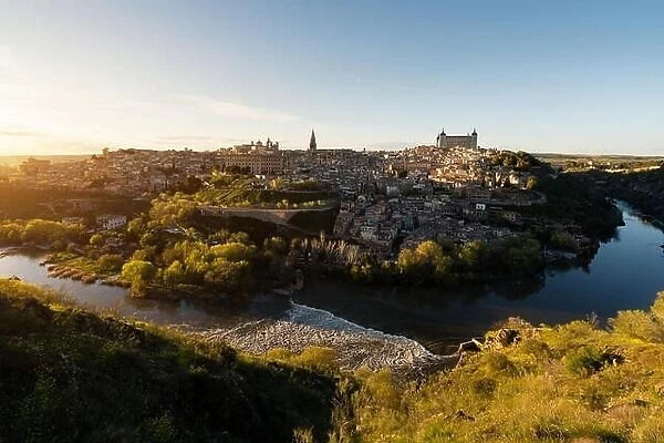 Panoramic view of the medieval center of the city of Toledo, Spain. It features the Tejo river, the Cathedral and Alcazar of Toledo, Spain