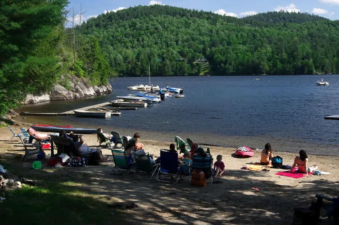 Framed Print : Paradox Lake, residents sit in beach chairs in the shade at water's edge, boats at the dock Framed Print : Paradox Lake, residents sit in beach chairs in the shade at water's edge, boats at the dock