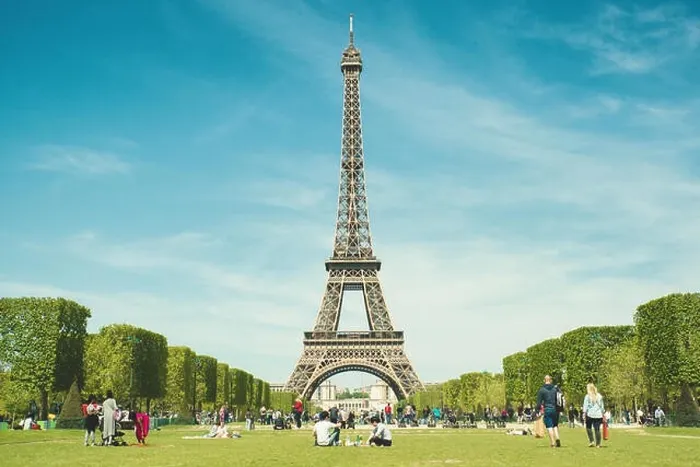 Framed Print : Paris, France - May 6, 2016 : Tourists chilling in park near Eiffel Tower Paris, France. In year 2016 more than 15 million tourists visited the city of Framed Print : Paris, France - May 6, 2016 : Tourists chilling in park near Eiffel Tower Paris, France. In year 2016 more than 15 million tourists visited the city of