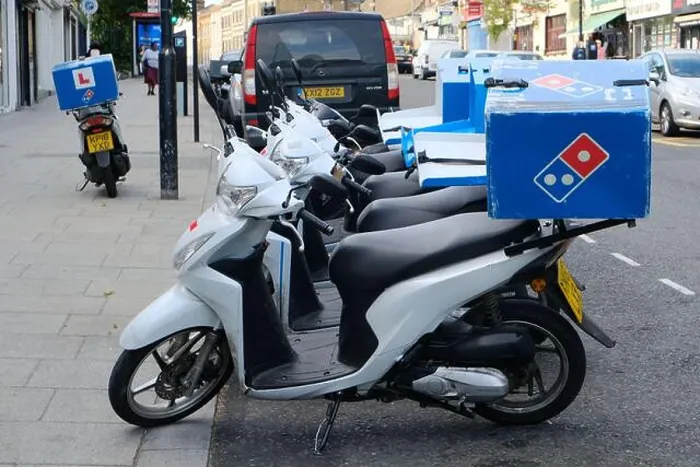 Framed Print : Parked mopeds used for home delivery of Dominos Pizzas on a roadside Framed Print : Parked mopeds used for home delivery of Dominos Pizzas on a roadside