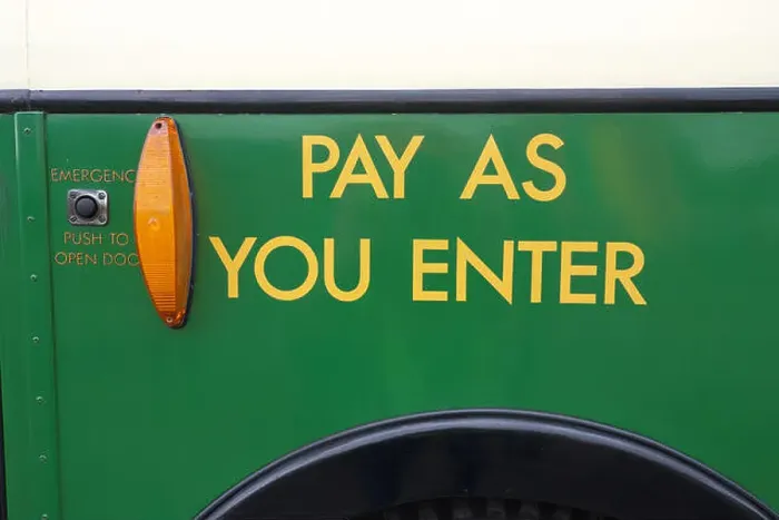 Framed Print : Pay As You Enter sign on the outside by the front door of a bus from the 1960s Framed Print : Pay As You Enter sign on the outside by the front door of a bus from the 1960s