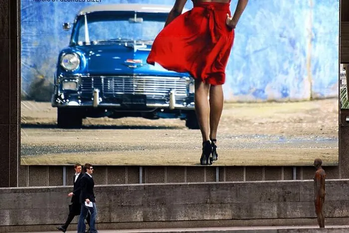 Framed Print : Pedestrians, under a huge billboard in the background Framed Print : Pedestrians, under a huge billboard in the background