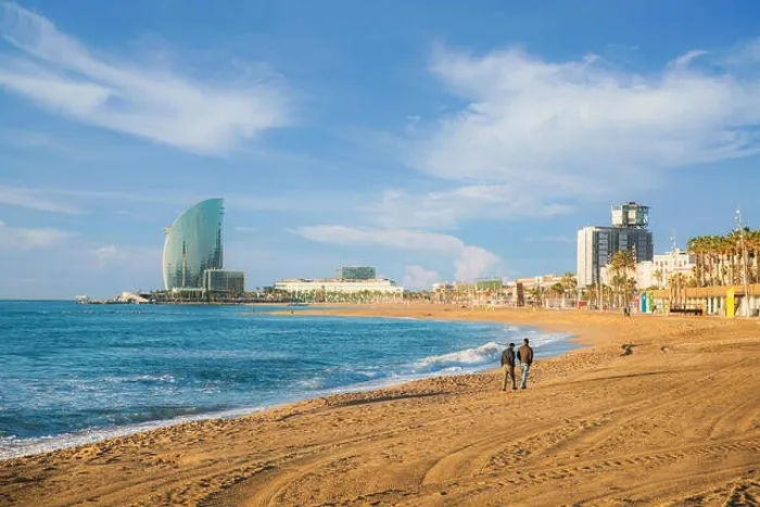 Framed Print : Pedestrians walk along Barceloneta Beach in Barcelona with colorful sky at sunrise. Seafront, beach, coast in Spain. Suburb of Barcelona, Catalonia Framed Print : Pedestrians walk along Barceloneta Beach in Barcelona with colorful sky at sunrise. Seafront, beach, coast in Spain. Suburb of Barcelona, Catalonia
