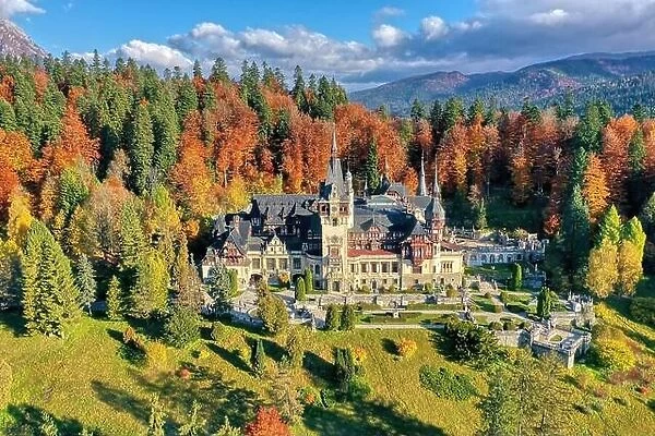 Peles Castle, Sinaia, Prahova County, Romania: Drone view of famous Neo-Renaissance castle in autumn colours, at the base of the Carpathian Mountains