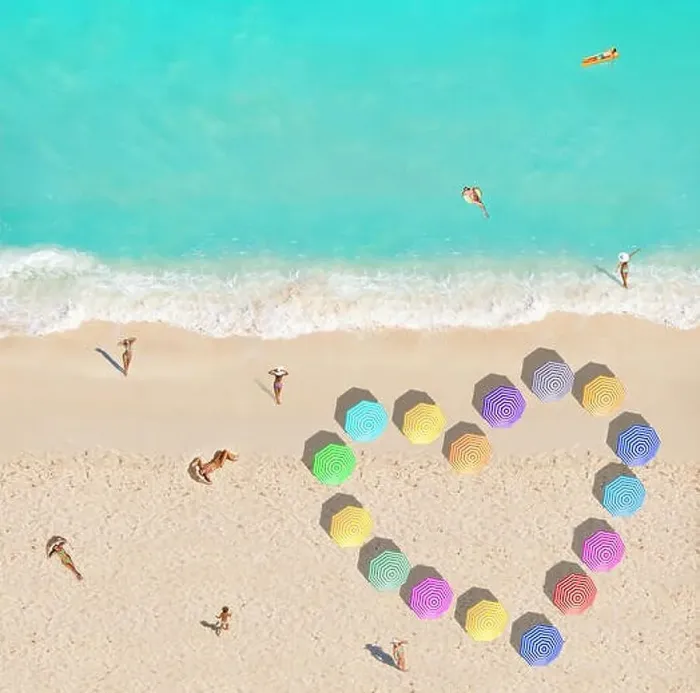 Framed Print : People on beach and heart shape made of umbrellas Framed Print : People on beach and heart shape made of umbrellas