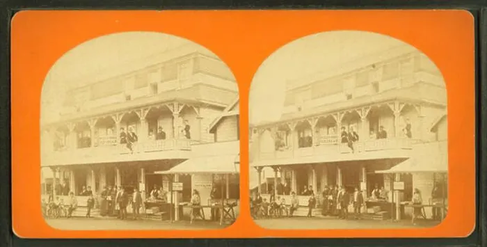 Framed Print : People gathered in front of and on the balcony of a large building