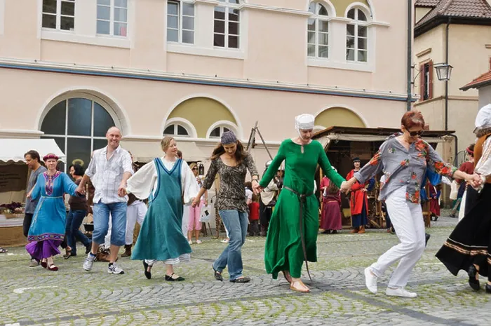 Framed Print : People in historic costumes dancing ethnic folkloristic dance on the street Framed Print : People in historic costumes dancing ethnic folkloristic dance on the street