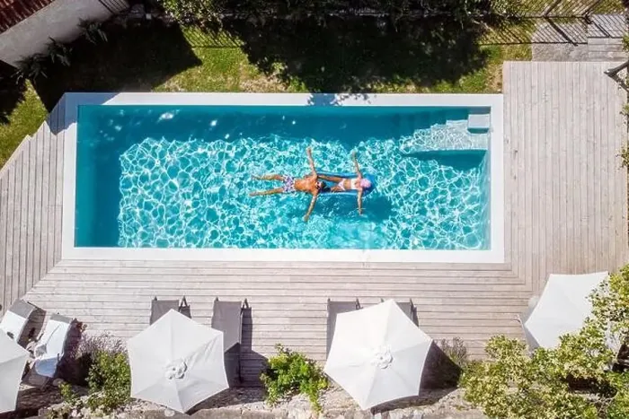 Framed Print : two people swim in the pool at the hotel