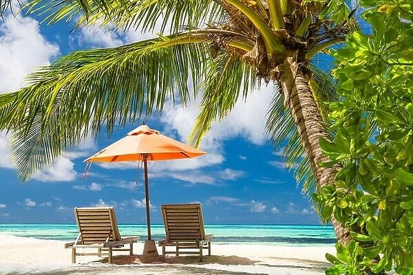 Perfect beach banner, two sun chairs and umbrella in tropical landscape. Tranquil exotic nature scenery. Luxury resort for summer vacation and holiday
