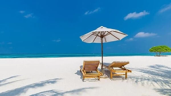 Perfect couple and romantic love beach background. Two lounge chairs and umbrella on white sand near the sea. Luxury vacation and holiday concept