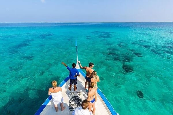 Perfect summer holiday concept in Maldives island. Dhoni boat in blue sea heading over tropical beach, white sand, palm trees, luxury travel banner