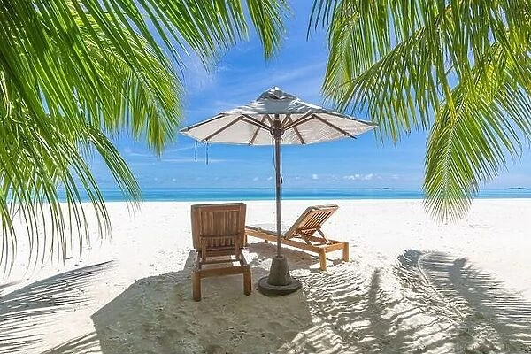 Perfect sunny beach. Idyllic tropical beach landscape for background. Couple honeymoon, romantic destination, freedom lounge chairs umbrella palm sand