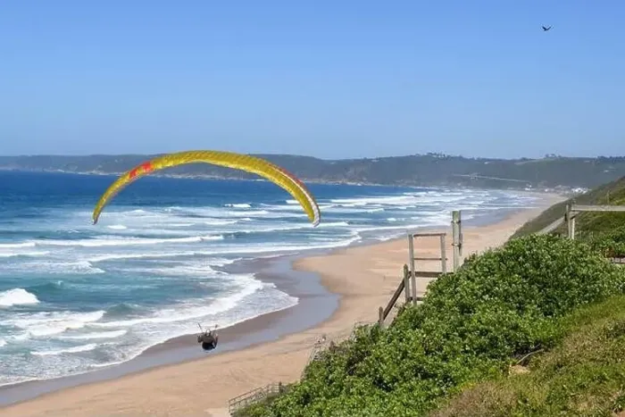 Framed Print : Person flying his paraglider on the beach of Wilderness in South Africa
