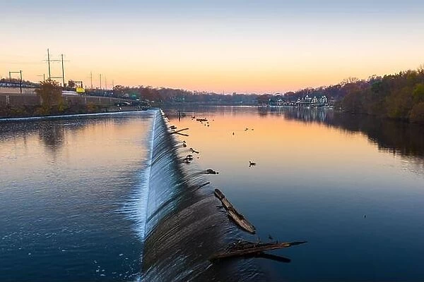 Philadelphia, Pennsylvania, USA dam on the Schuylkill River with Boathouse Row in the distance at dawn