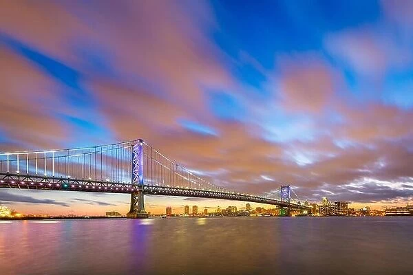Philadelphia, Pennsylvania, USA skyline on the Delaware river with Ben Franklin Bridge at night