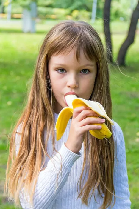Framed Print : Photo of girl are eating banana in summer Framed Print : Photo of girl are eating banana in summer