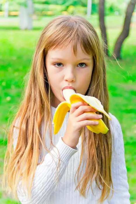 Framed Print : Photo of girl are eating banana in summer Framed Print : Photo of girl are eating banana in summer