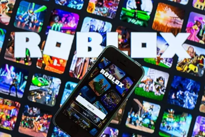Framed Print : In this photo illustration, the Roblox app seen displayed on a smartphone screen and a Roblox logo in the background Framed Print : In this photo illustration, the Roblox app seen displayed on a smartphone screen and a Roblox logo in the background