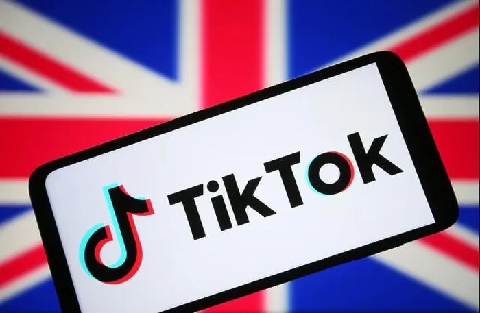 Framed Print : In this photo illustration, a TikTok logo is seen on a smartphone and flag of United Kingdom (UK) in the background Framed Print : In this photo illustration, a TikTok logo is seen on a smartphone and flag of United Kingdom (UK) in the background