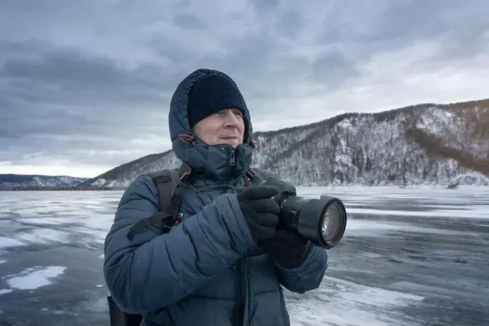 Framed Print : A photographer is capturing icy landscapes in winter gear amidst snowy mountains and frosty scenery Framed Print : A photographer is capturing icy landscapes in winter gear amidst snowy mountains and frosty scenery