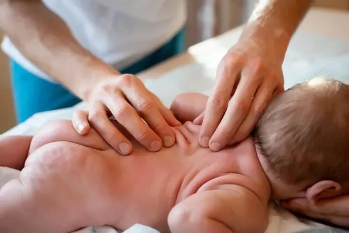 Framed Print : Picture from above of newborn baby and masseur hands Framed Print : Picture from above of newborn baby and masseur hands